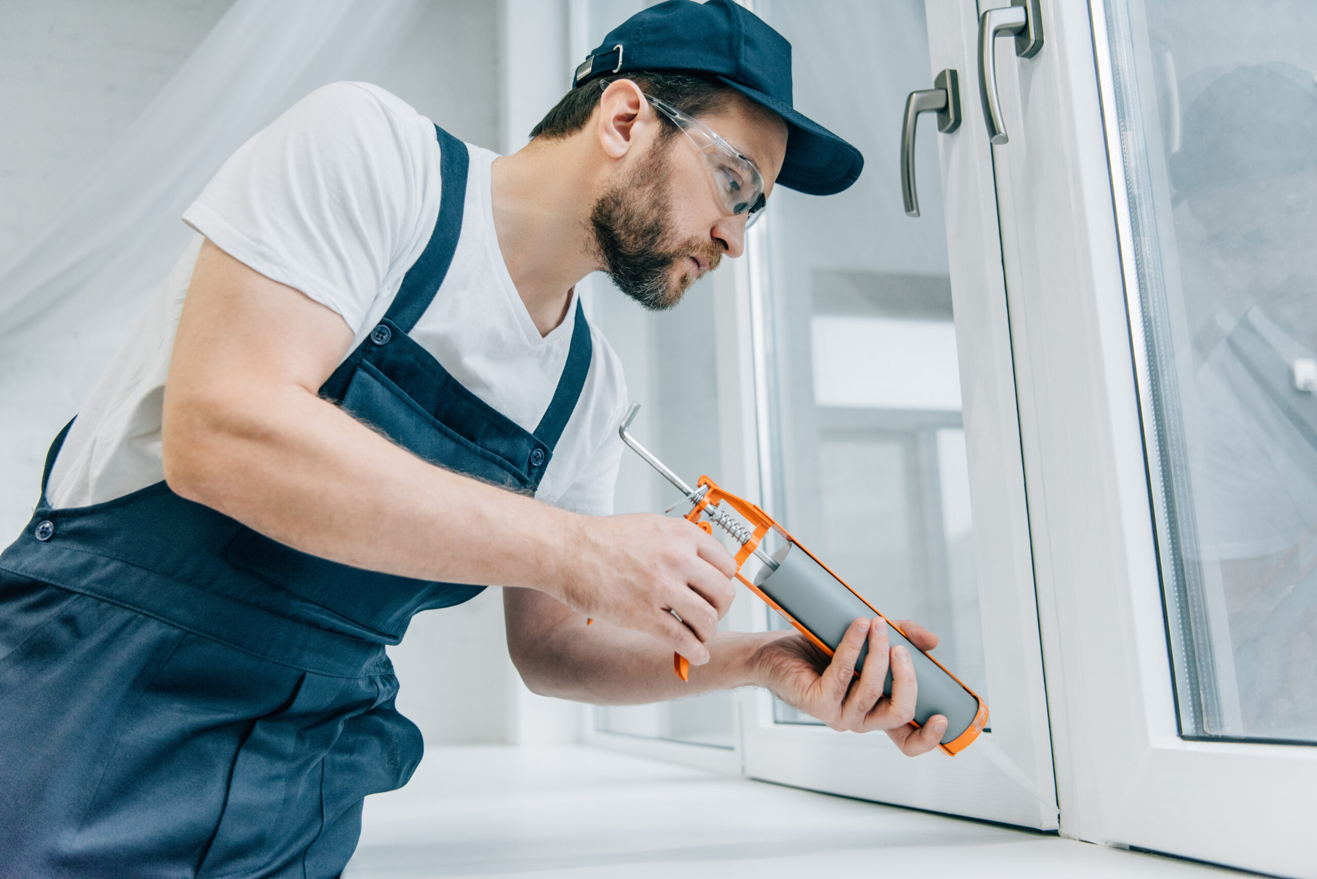 Technician putting final touches on new windows installed in home