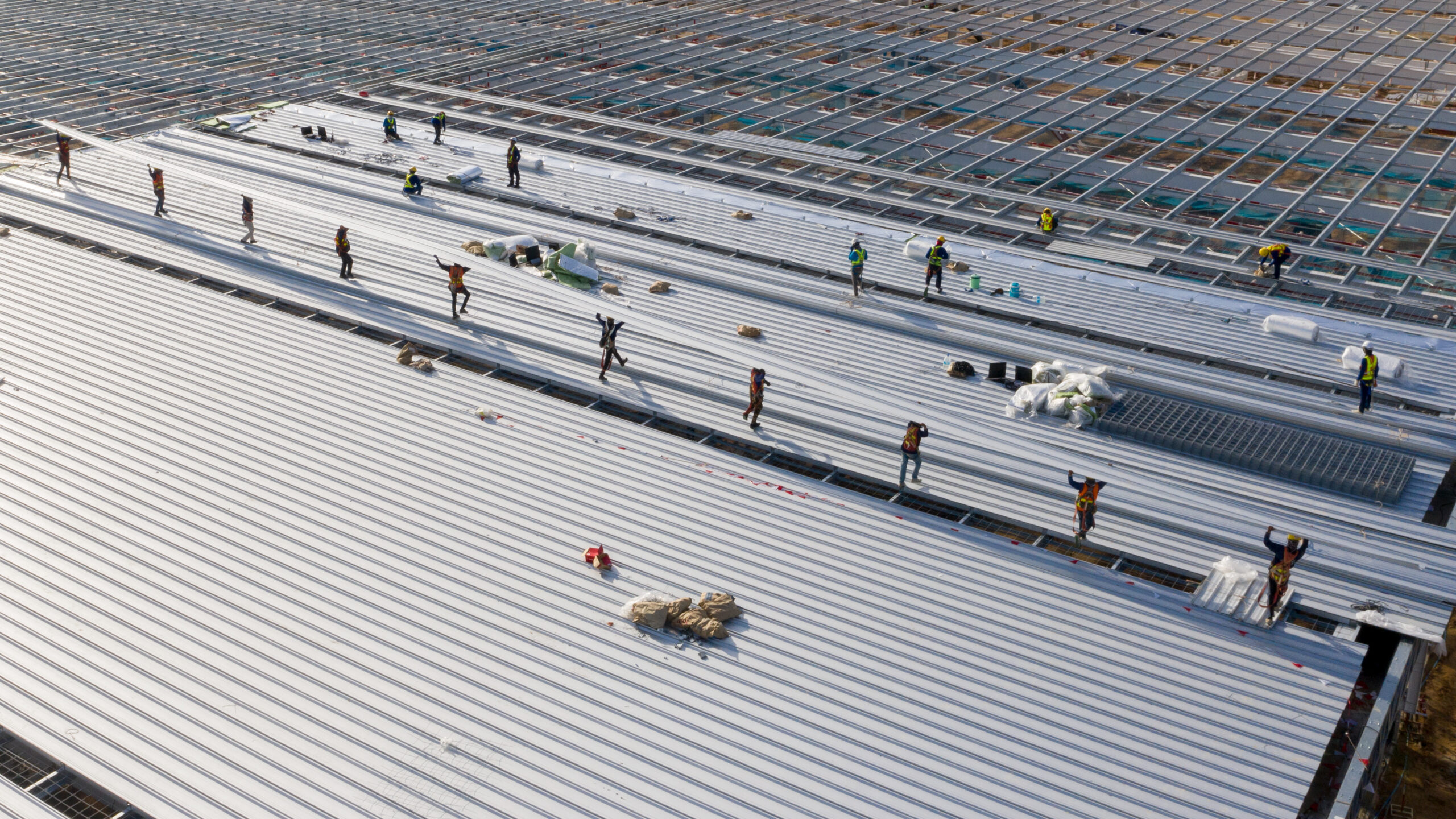 Aerial view of large commercial building with dark roof