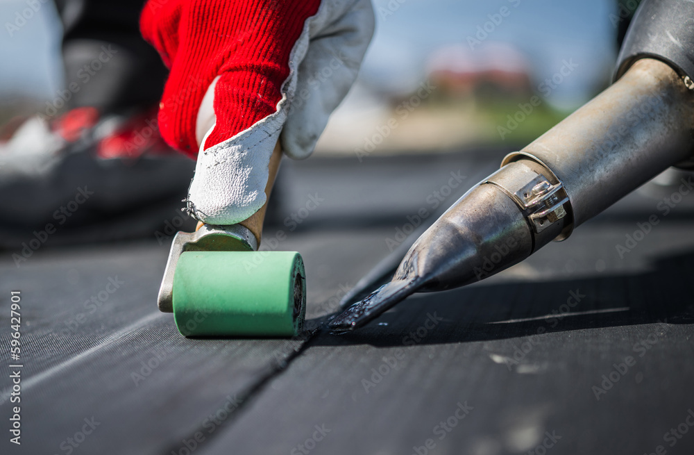 Close up of commercial grade tools being used to install an asphalt roof