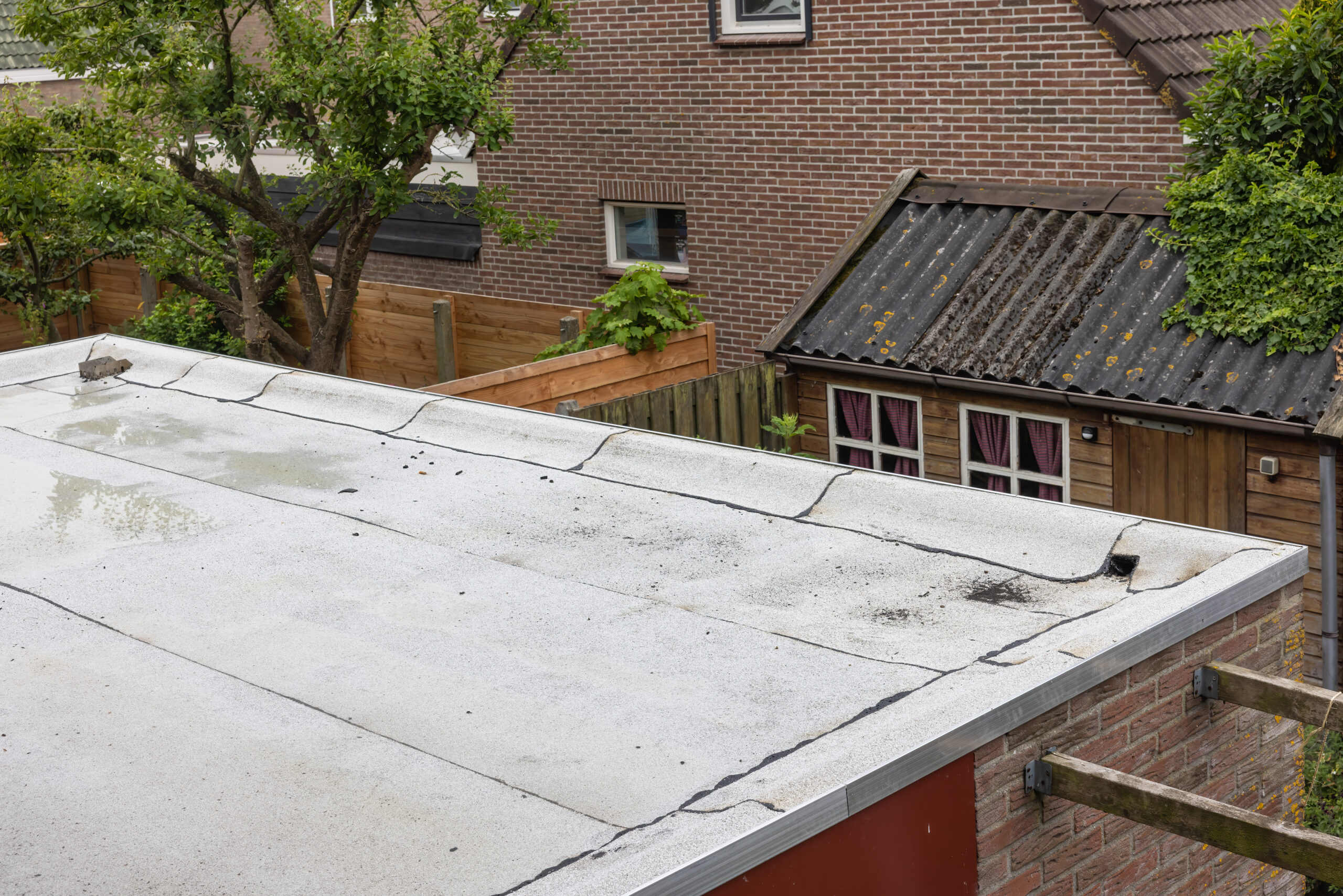 Flat roof on building that has puddles in need of repair