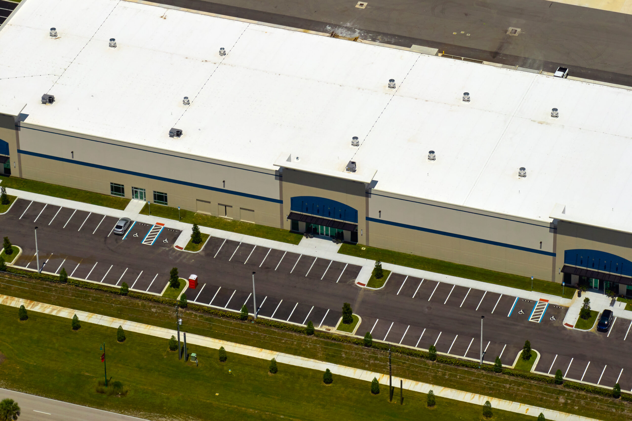 Flat white TPO roof recently replaced on commercial building