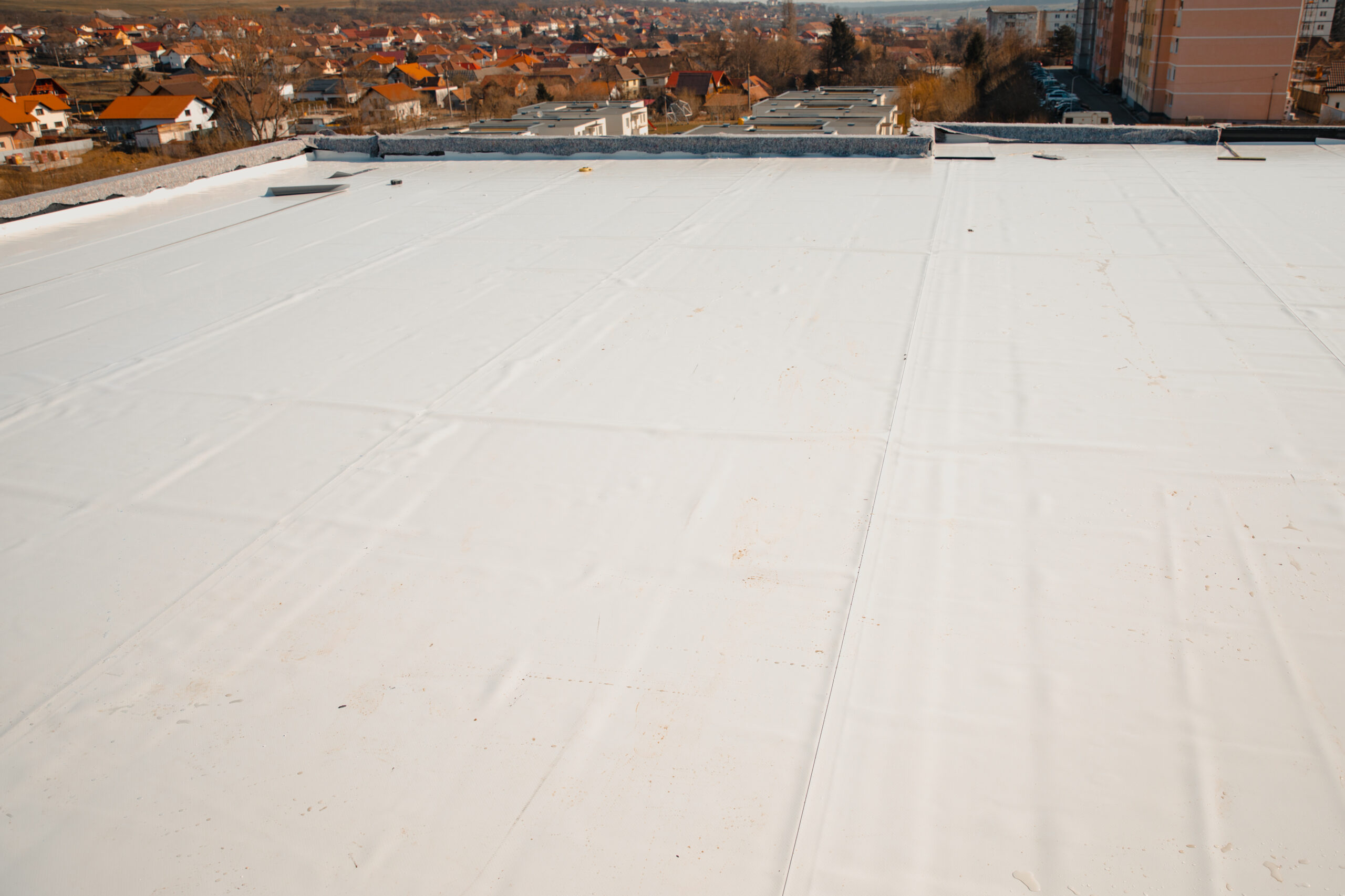 Newly installed white flat roof on building