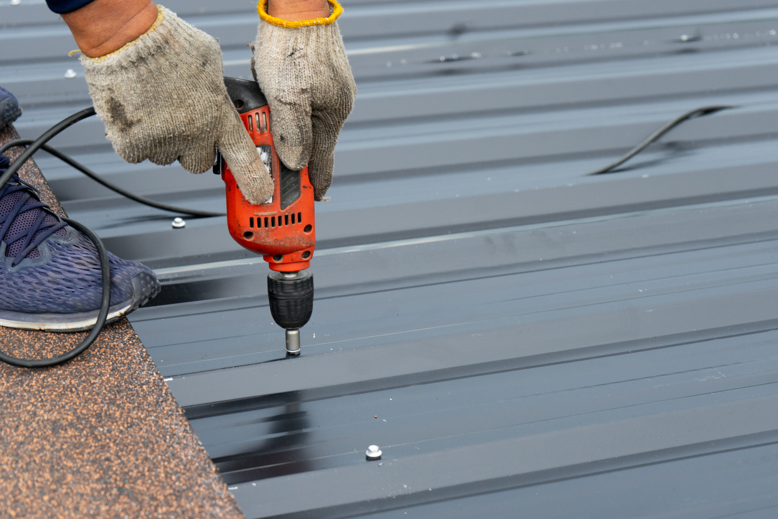 Close up view of metal roof being installed on building