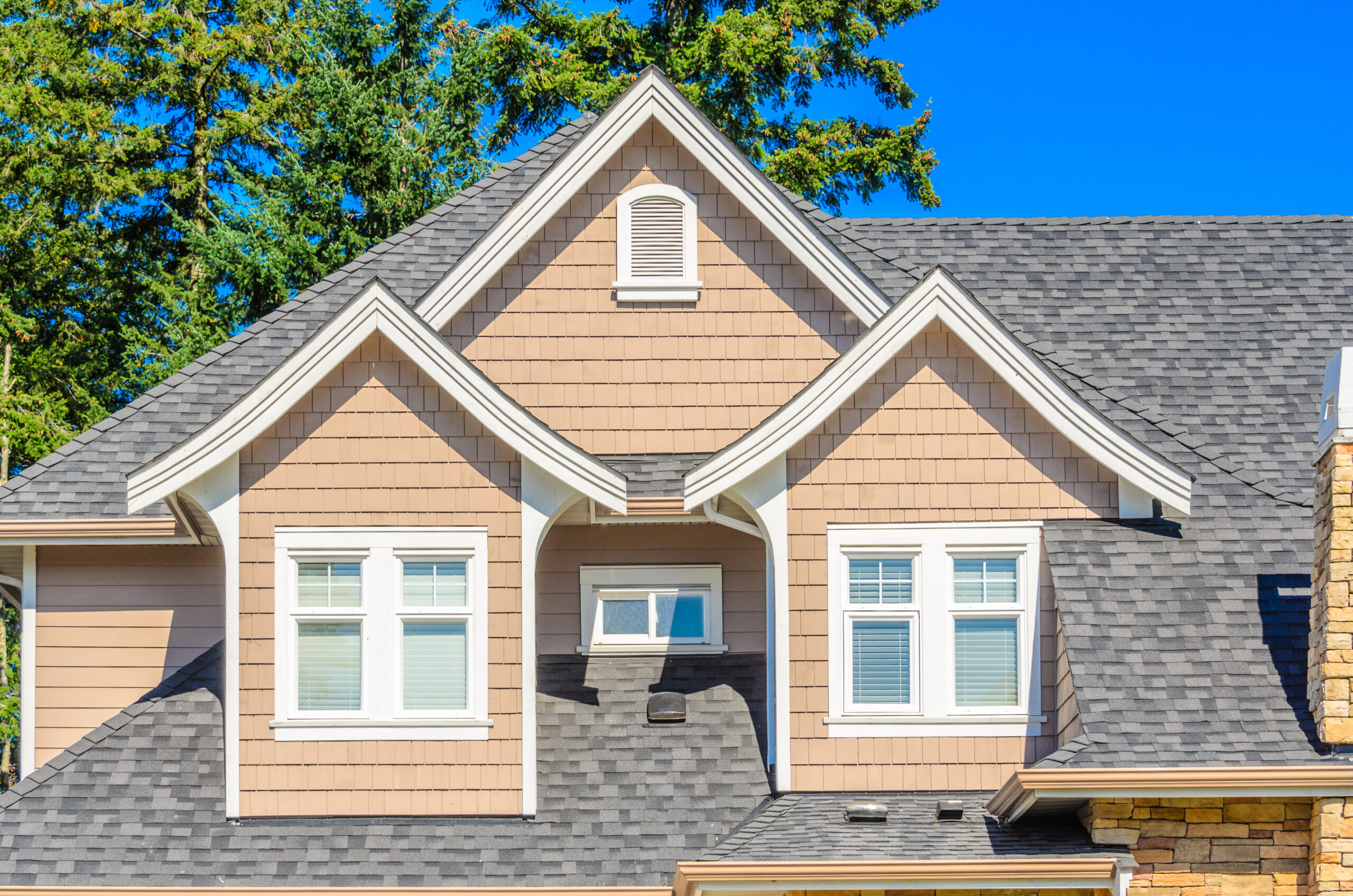 Gray asphalt roof on tan house