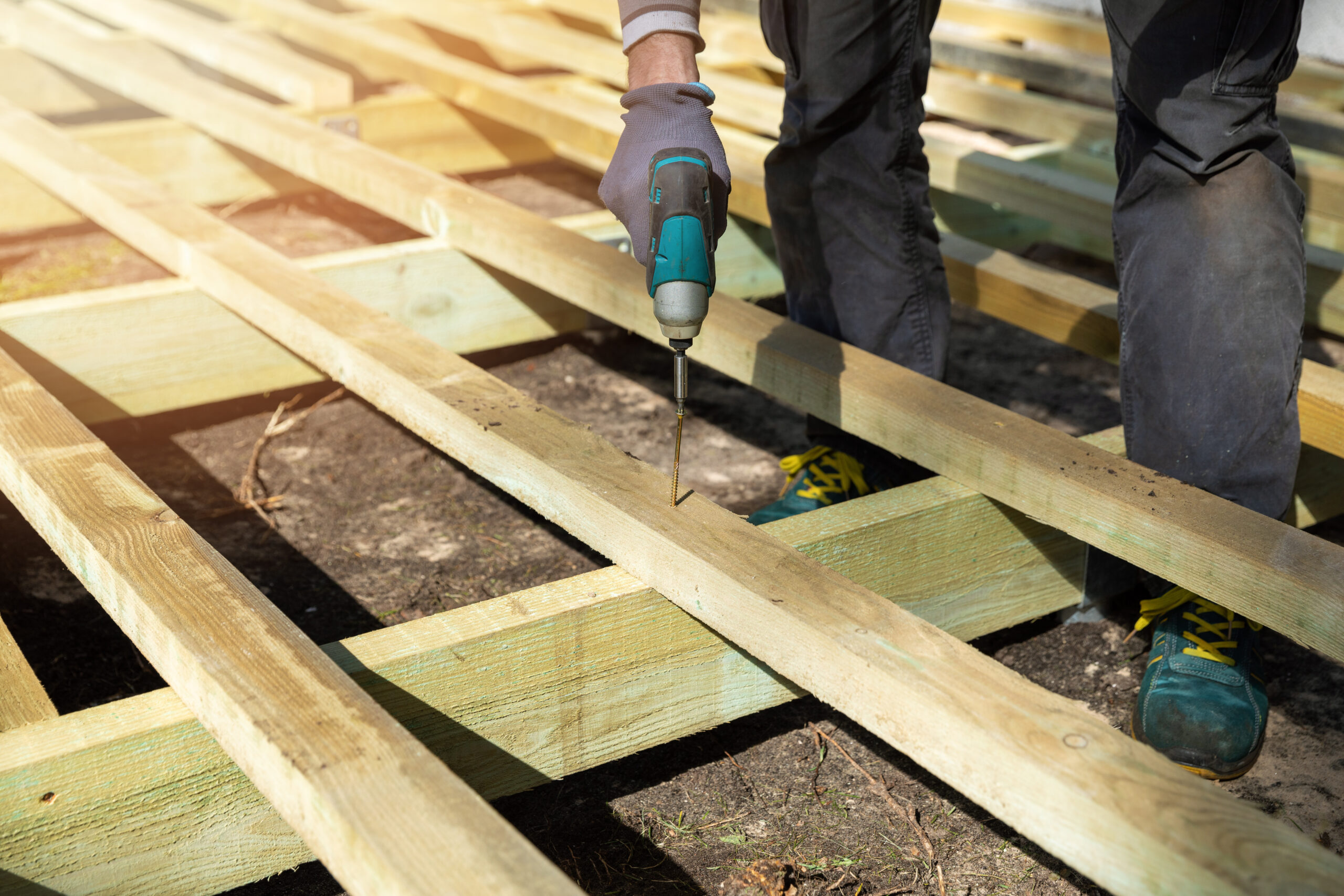 Worker building a new deck for a home