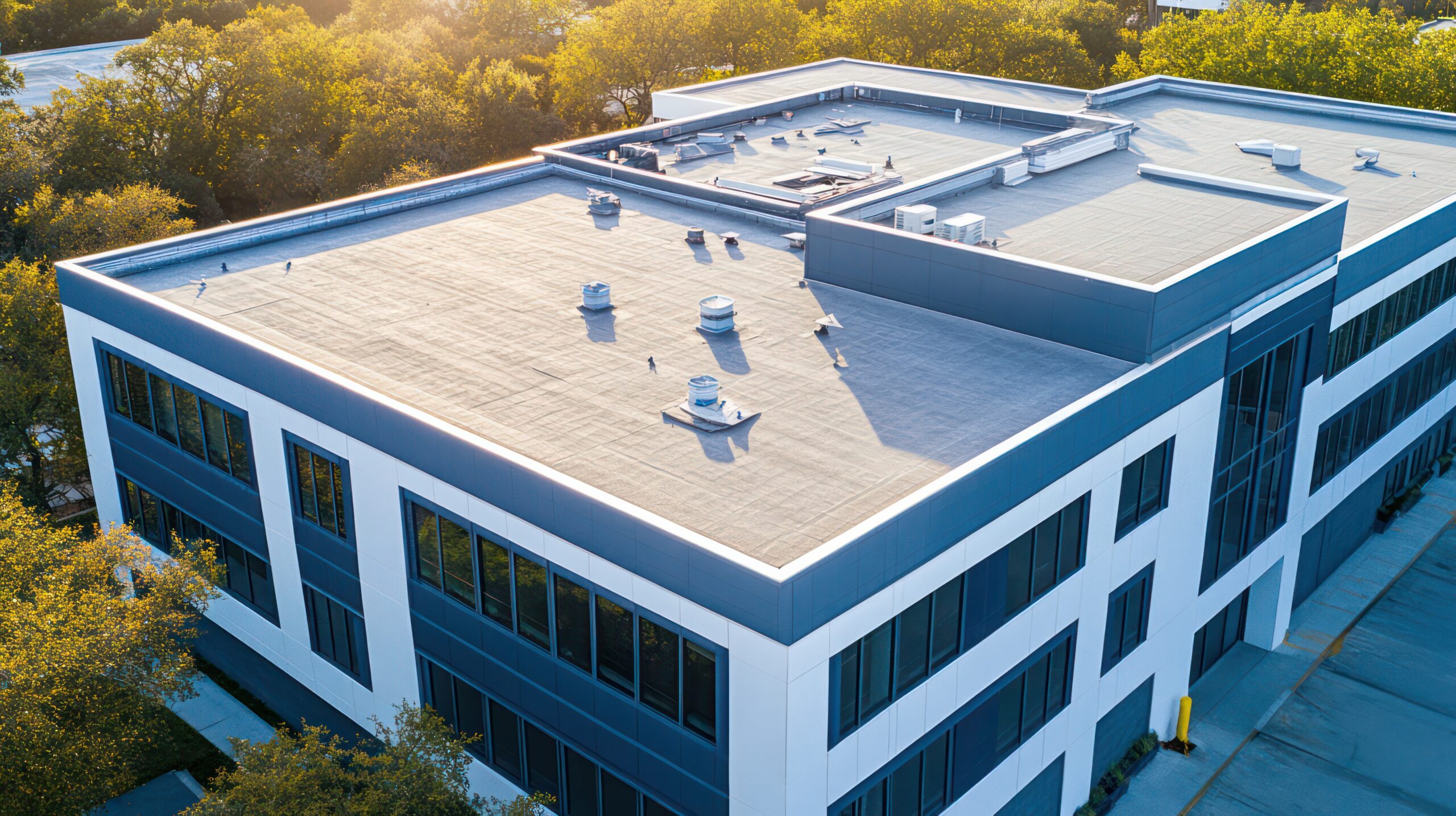 White commercial building with dark roof