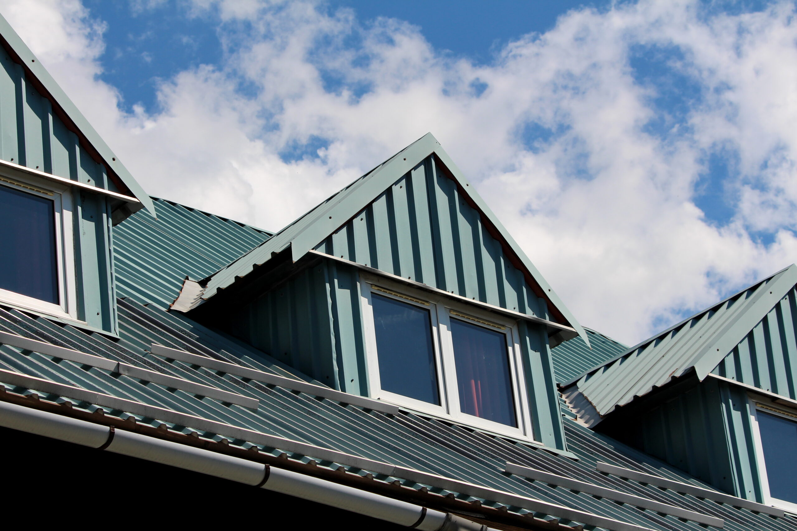 Green metal roof installed on home