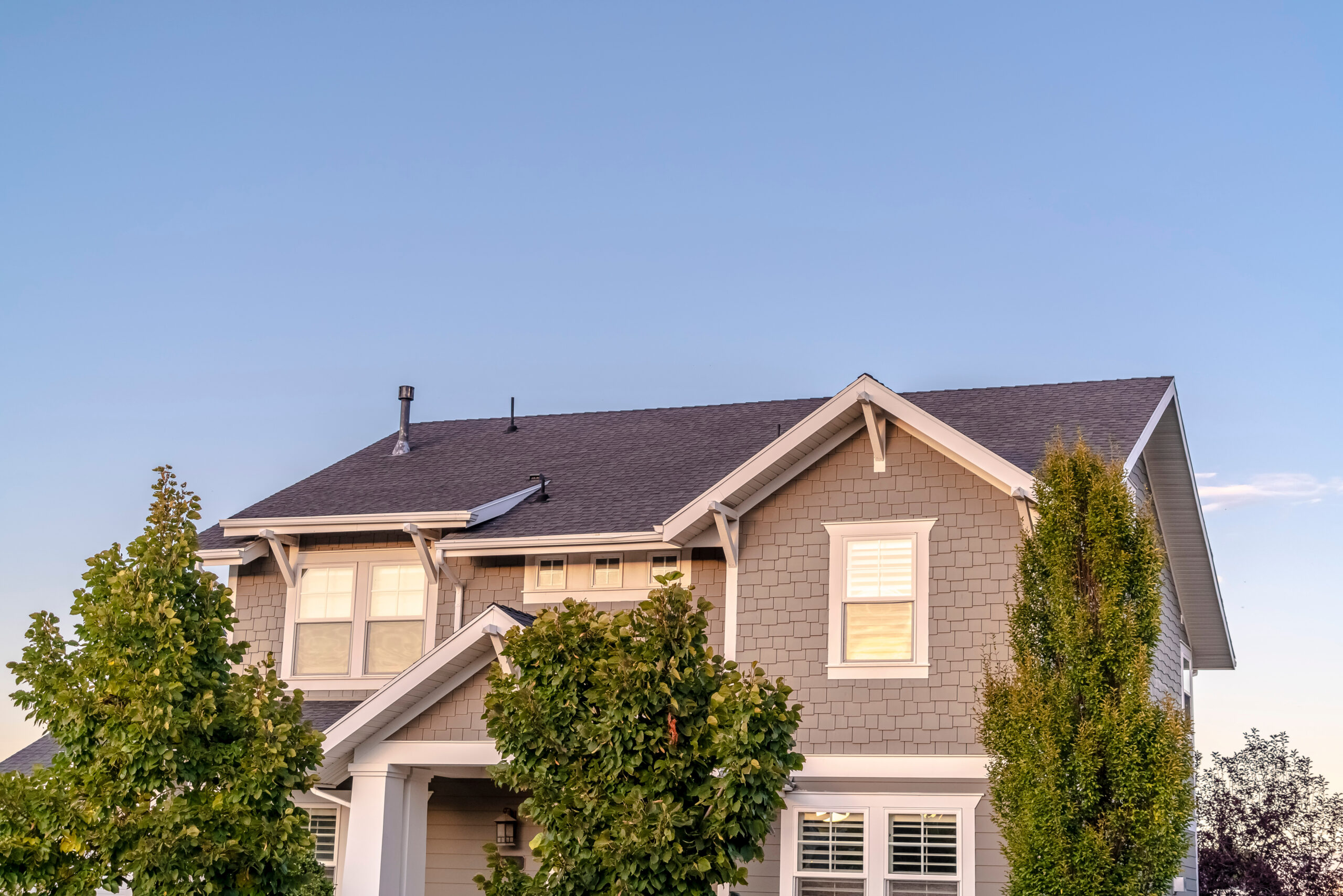 Beautiful gray asphalt roof on two story home