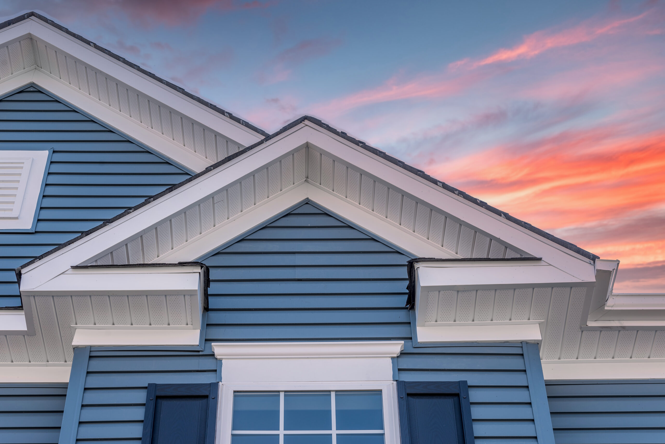 Blue siding on a house with a peaked roof