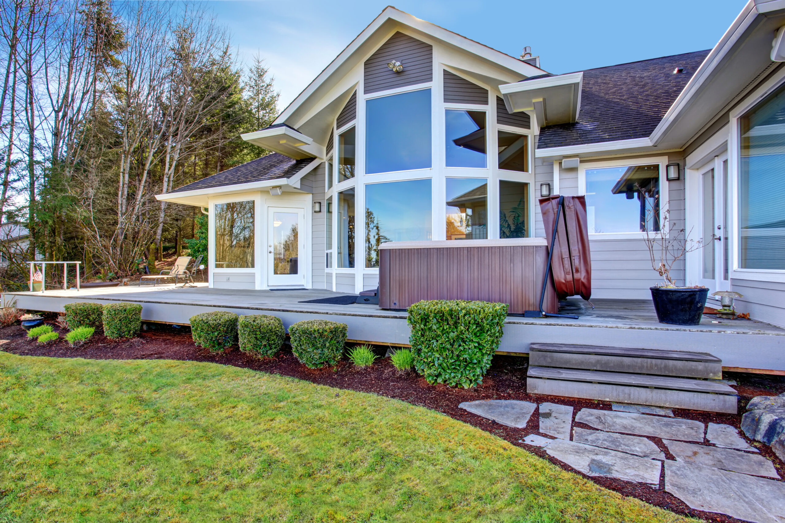 Big windows on fancy home with jacuzzi tub