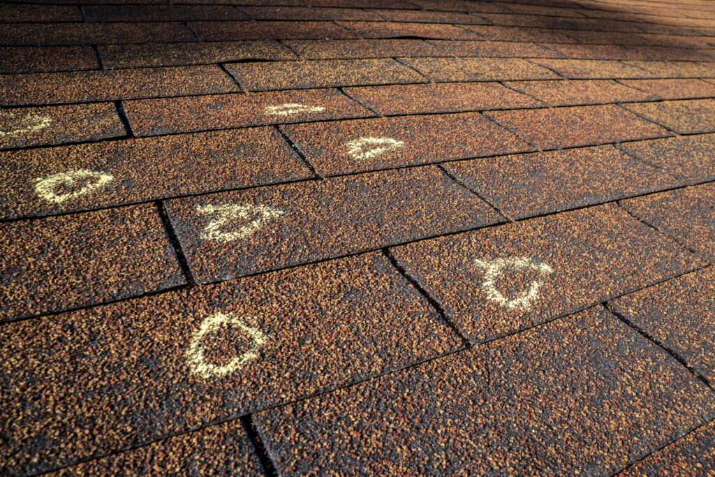 Hail damage marked on asphalt shingle roof