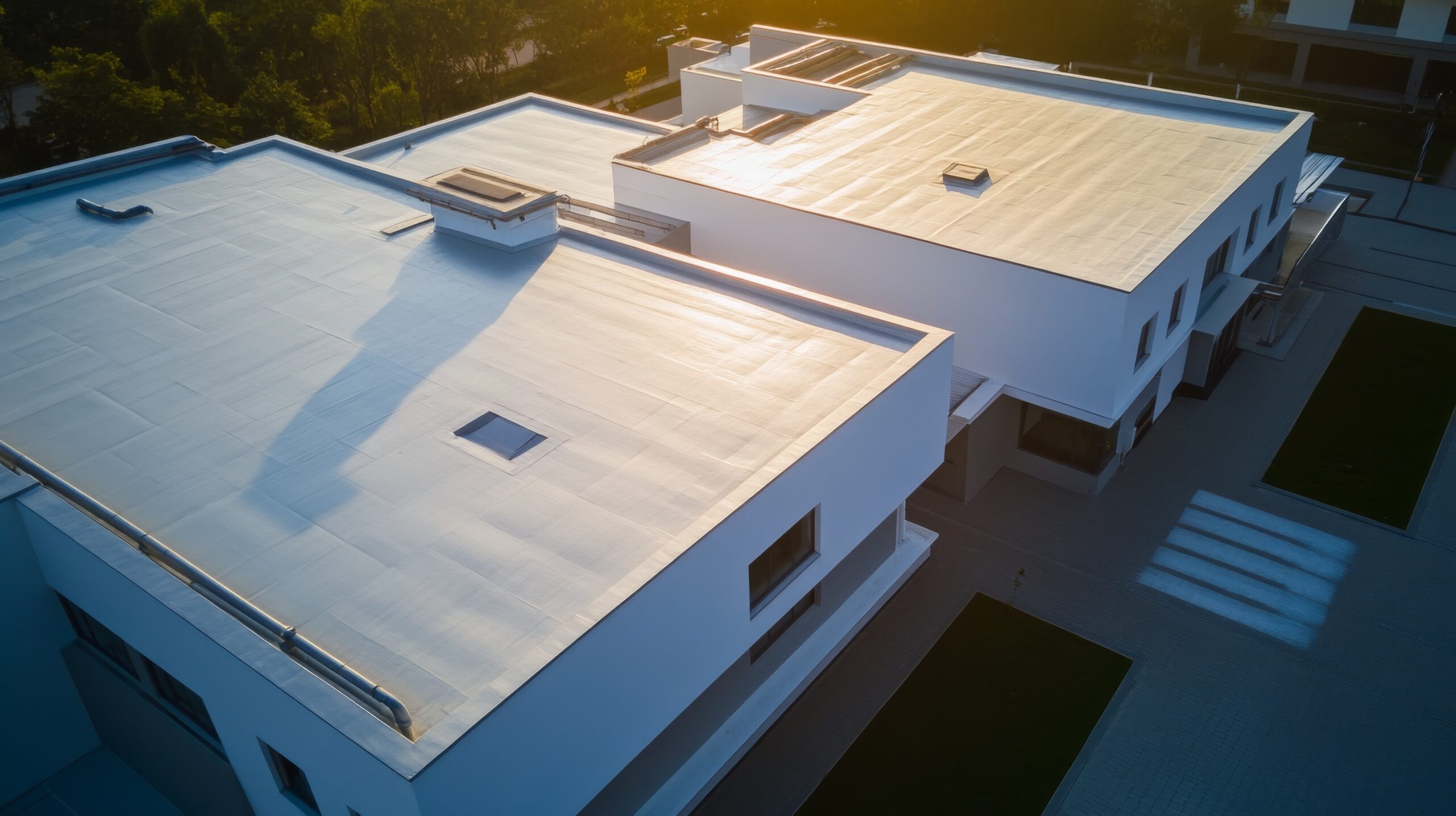 White flat roofs at sunset on commercial building